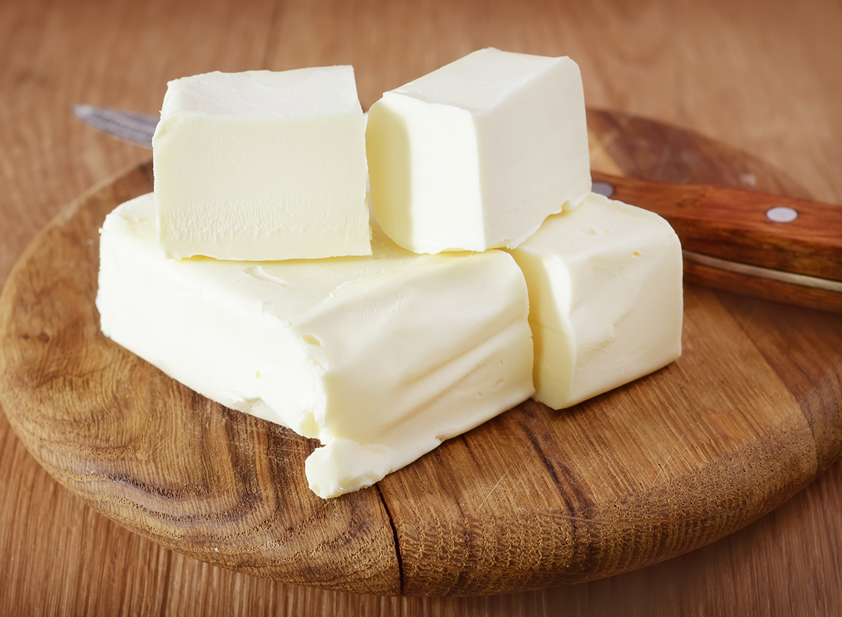the 30 worst cookie mistakes you're making 164 sticks of butter stacked on top of a wooden board next to a knife