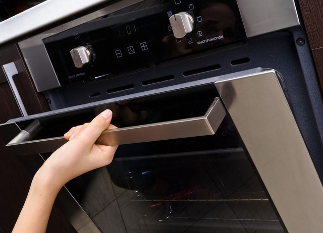 woman opening oven