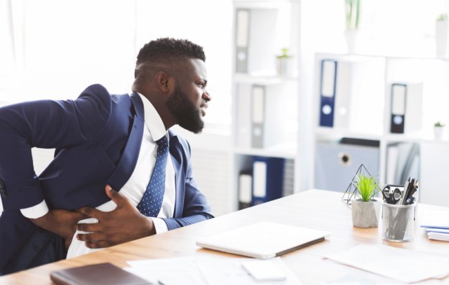 young man at work with liver pain