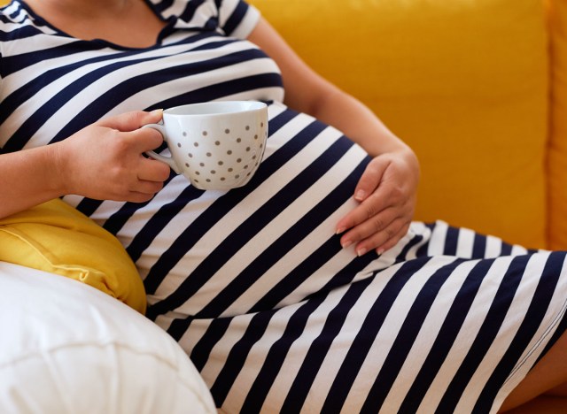 woman drinking coffee while pregnant