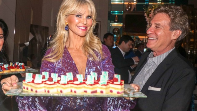 christie brinkley holding tray of cake