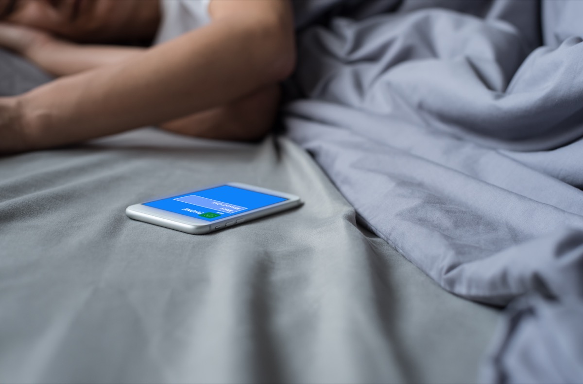7 nighttime habits making you gain weight, says science 32 missed call phone from someone via mobile smart phone while asian man sleeping on bed in late morning