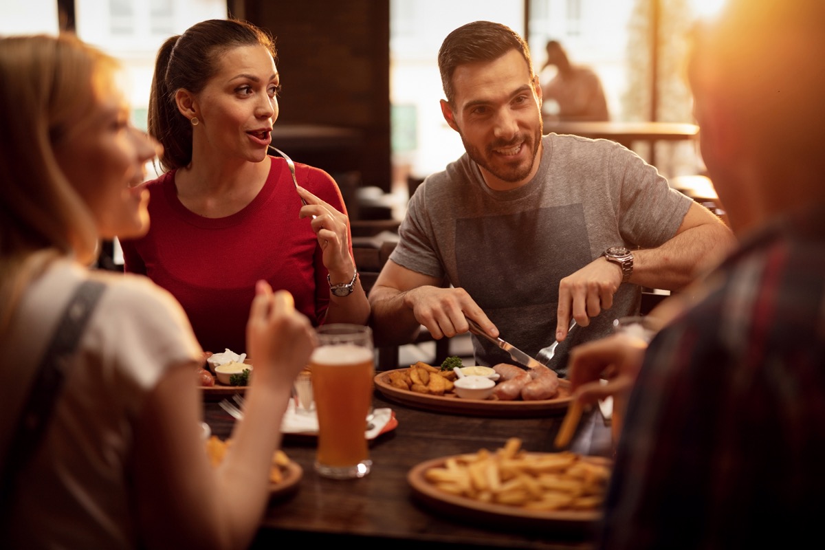 group of happy friends having a lunch in a tavern.