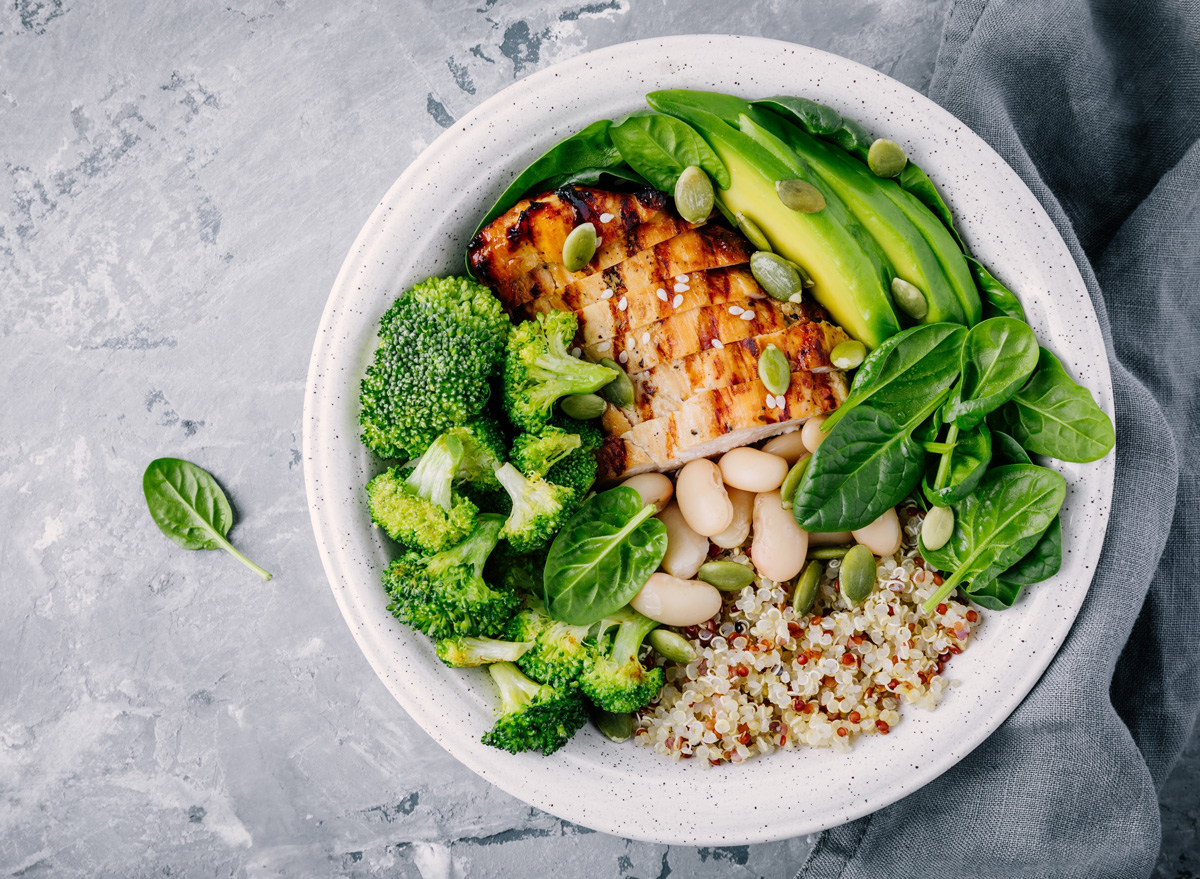 healthy quinoa lunch bowl with chicken as protein avocado as fat and vegetables broccoli and spinach and beans