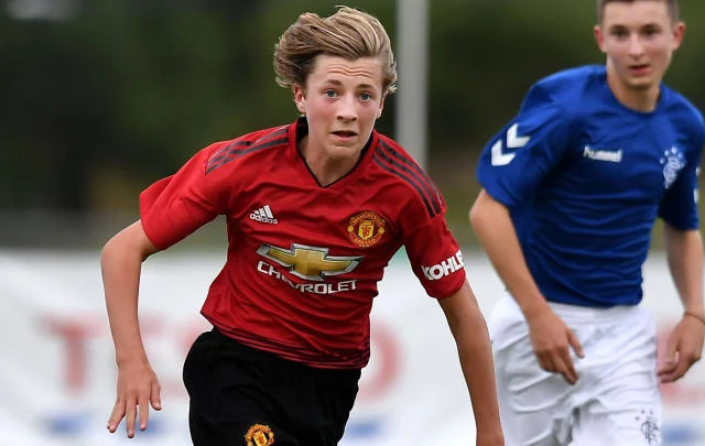 Charlie Savage signs his first professional contract with Manchester United