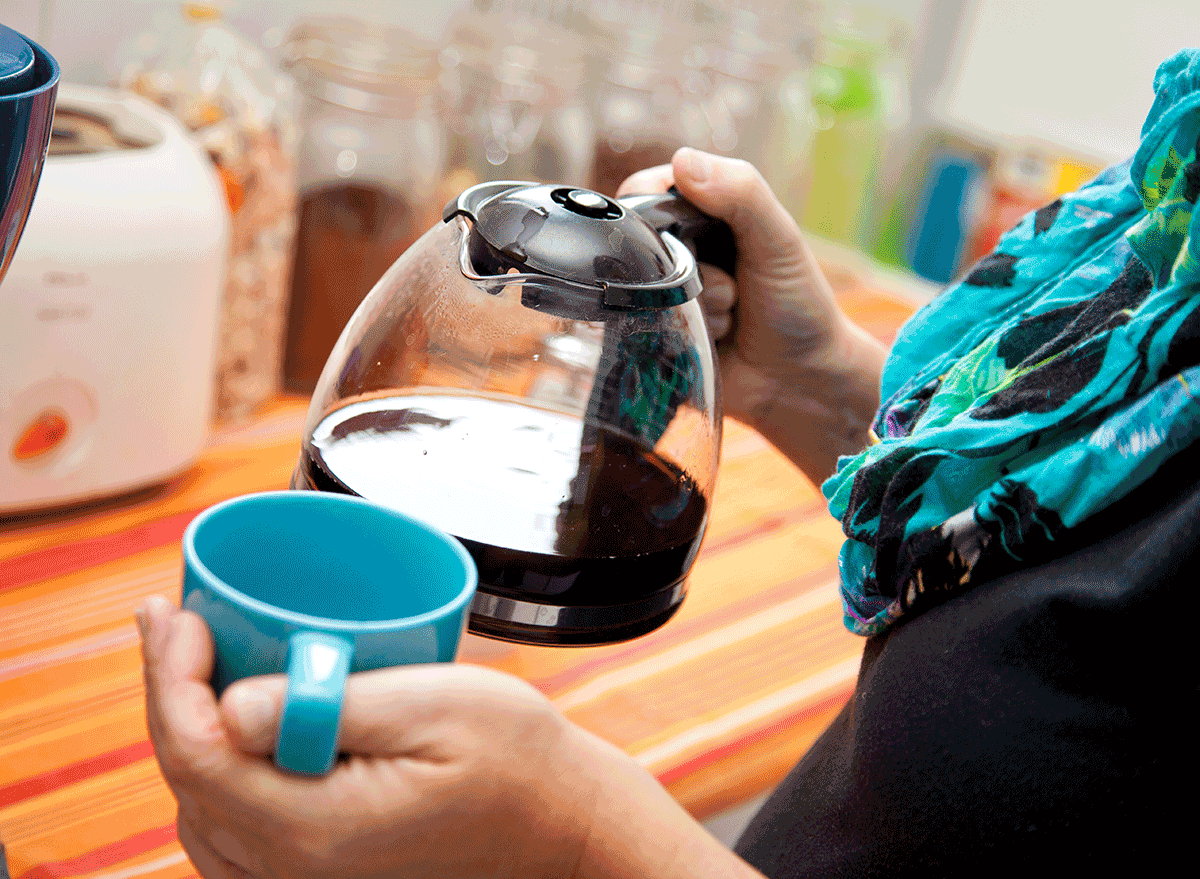 woman holding coffee pot and mug