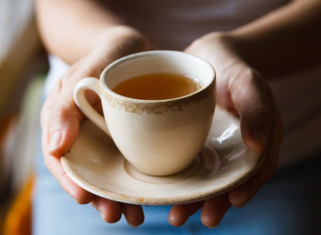 woman holding teacup in hands