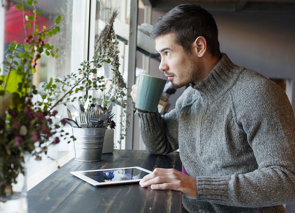 man with coffee ipad