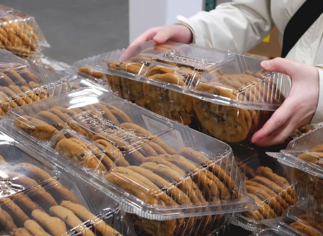 man grabbing multi pack bulk of cookies from costco