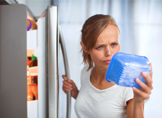 Woman checking expiration date on food