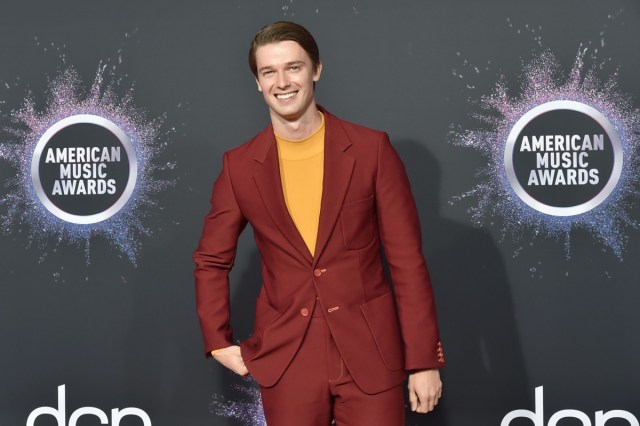 patrick schwarzenegger in red suit and yellow shirt on the red carpet