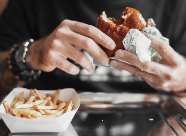 person eating burger and fries