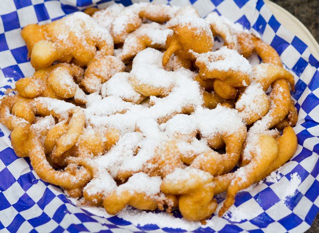 funnel cake with powdered sugar on paper
