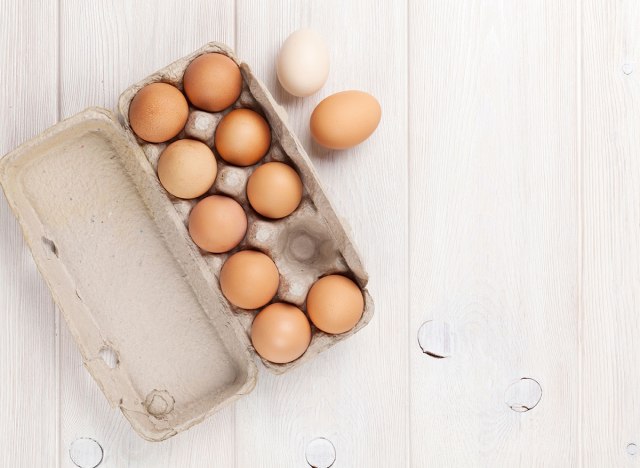 eggs in carton on wood table