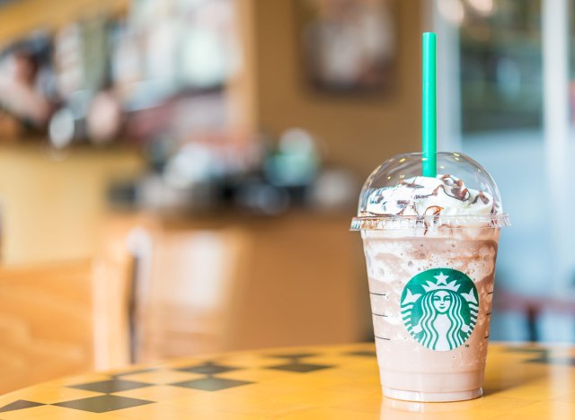 starbucks frappuccino on table with green straw