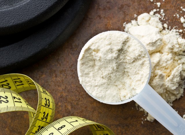 scoop of protein powder with weight loss measuring tape