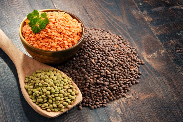 composition with bowl of lentils on wooden table.