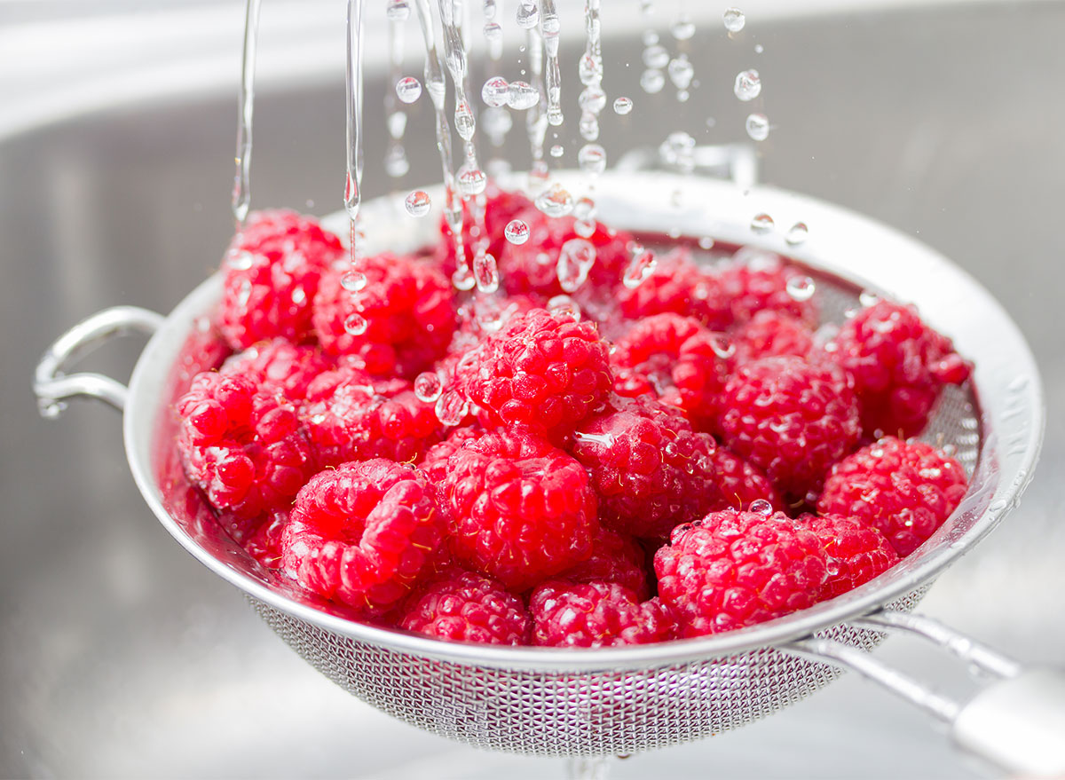 wash raspberries with water in the strainer