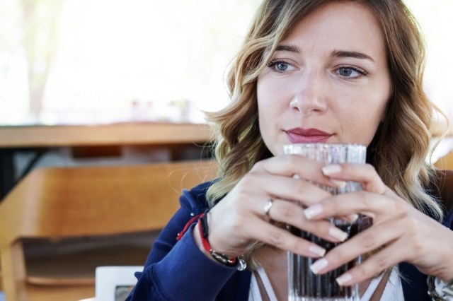 woman drinking soda outdoors