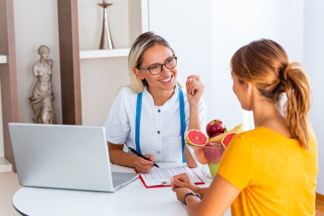 woman visiting nutritionist in weight loss clinic.