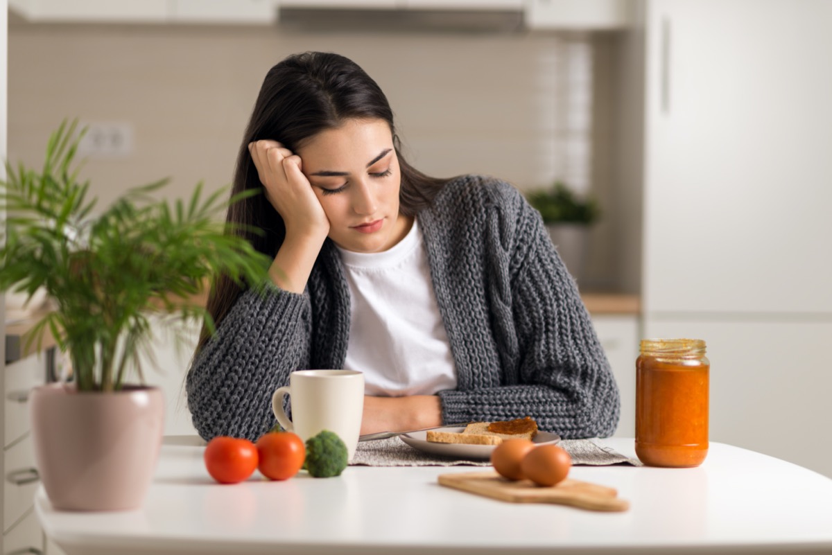 dissatisfied young woman does not want to eat her breakfast