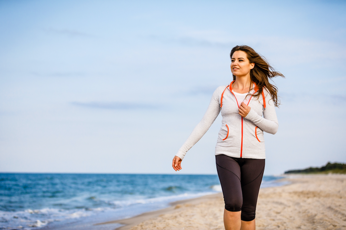 young woman walking on the beach