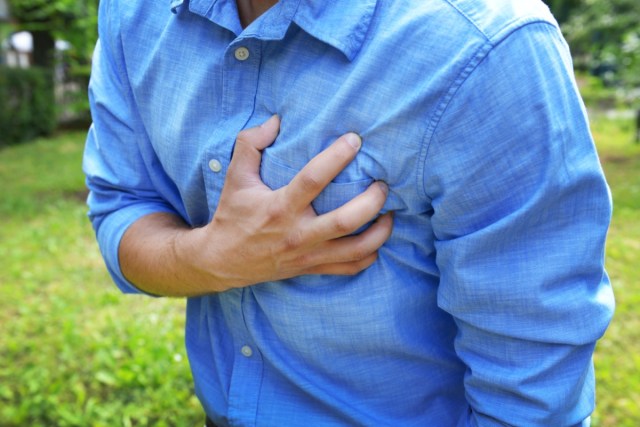 man having chest pain - heart attack, outdoors