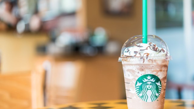 starbucks frappuccino on table with green straw