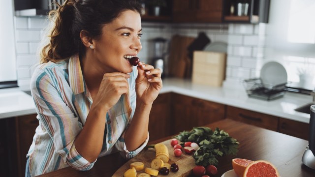 a young smiling woman having healthy breakfast in the morning