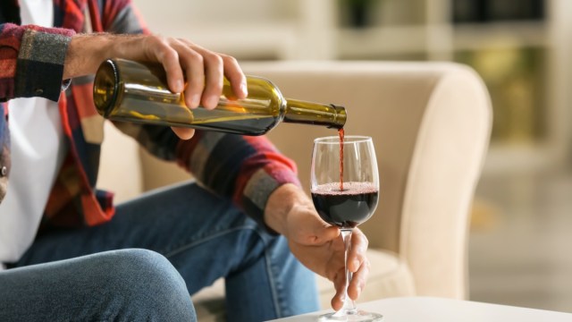 man pouring a glass of wine