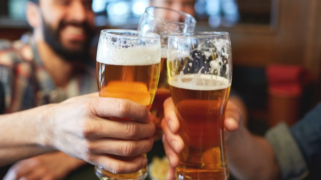 men drinking beer at a bar