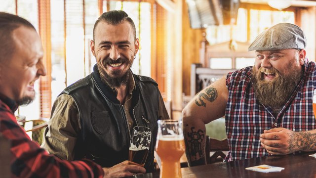men and boys drinking beer in a bar