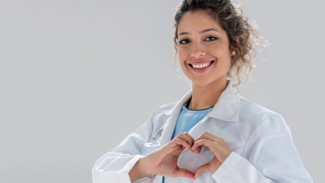 happy doctor making a heart shape and smiling