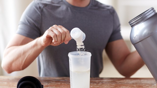 man making protein shake