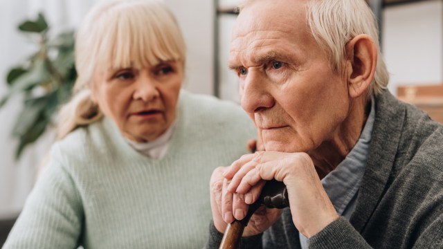 older man with dementia sitting next to wife