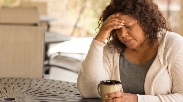 woman drinking coffee and thinking