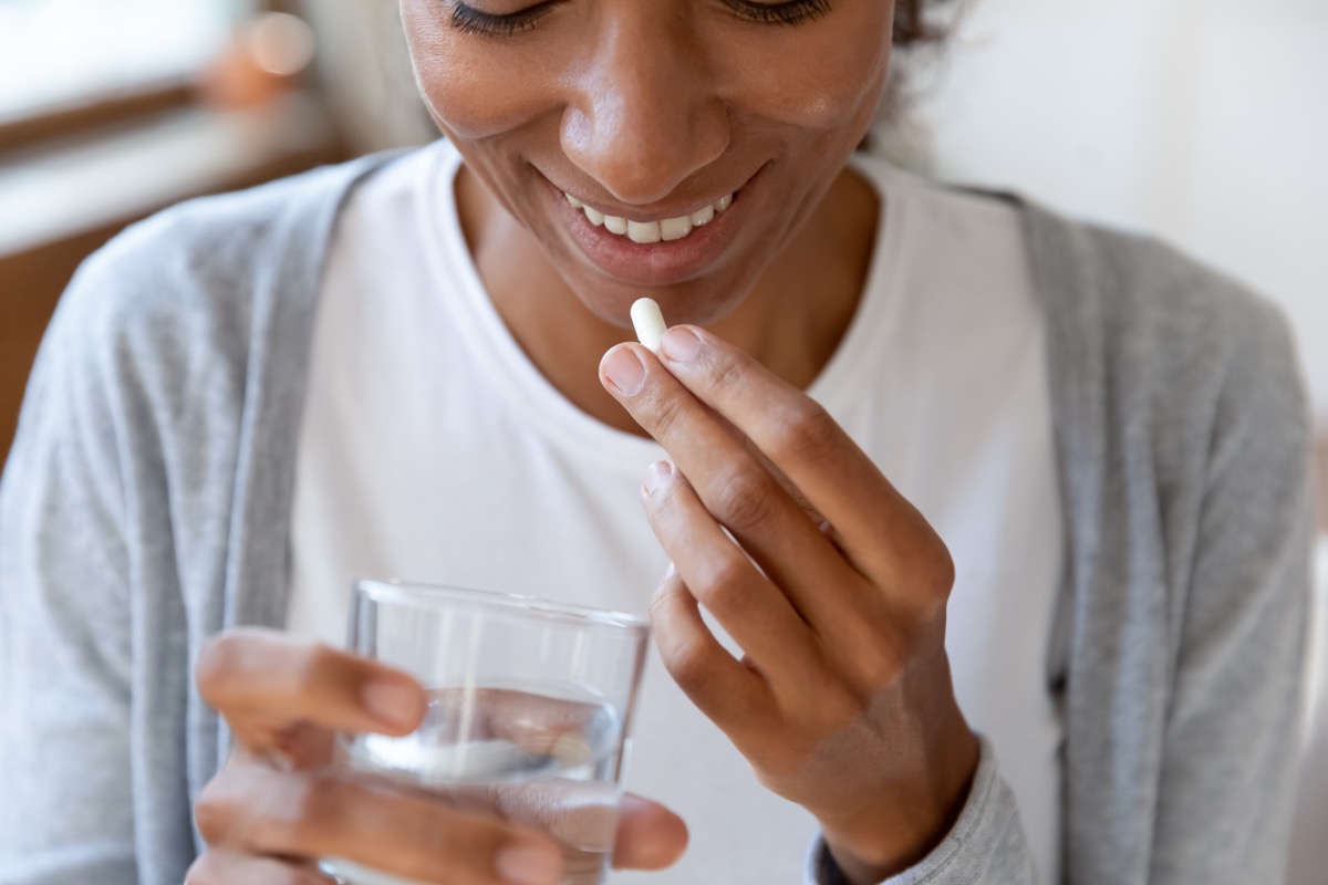 young woman taking supplements