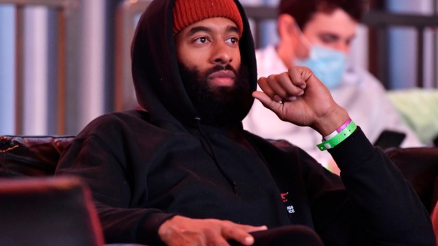 matt james watching a boxing match and wearing a beanie