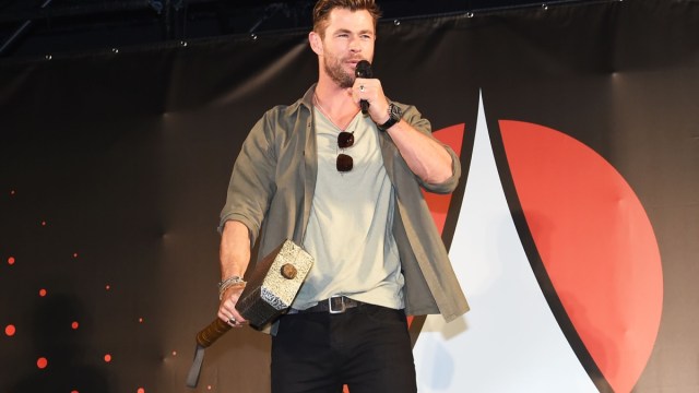 chris hemsworth holds thor's hammer