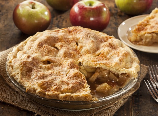 apple pie with slice and fresh apples