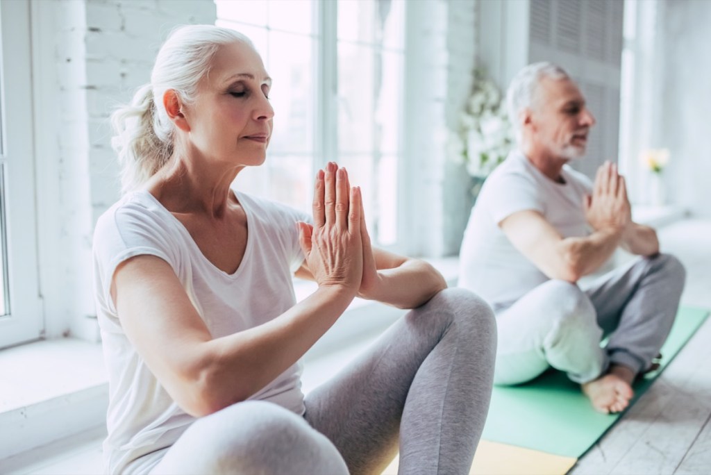 senior couple is doing fitness training at home.