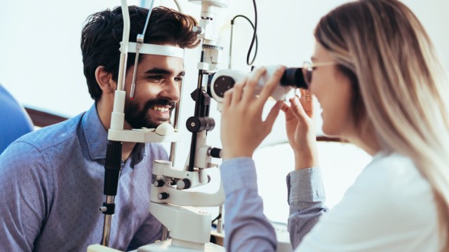 optometrist checking patient eyesight and vision correction