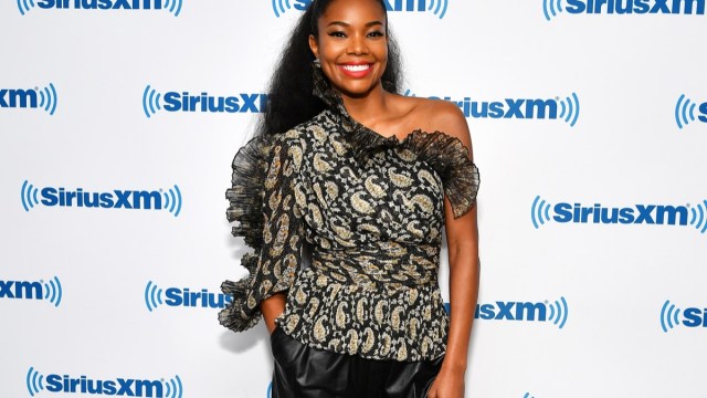 gabrielle union in black from shoulder top and red lipstick