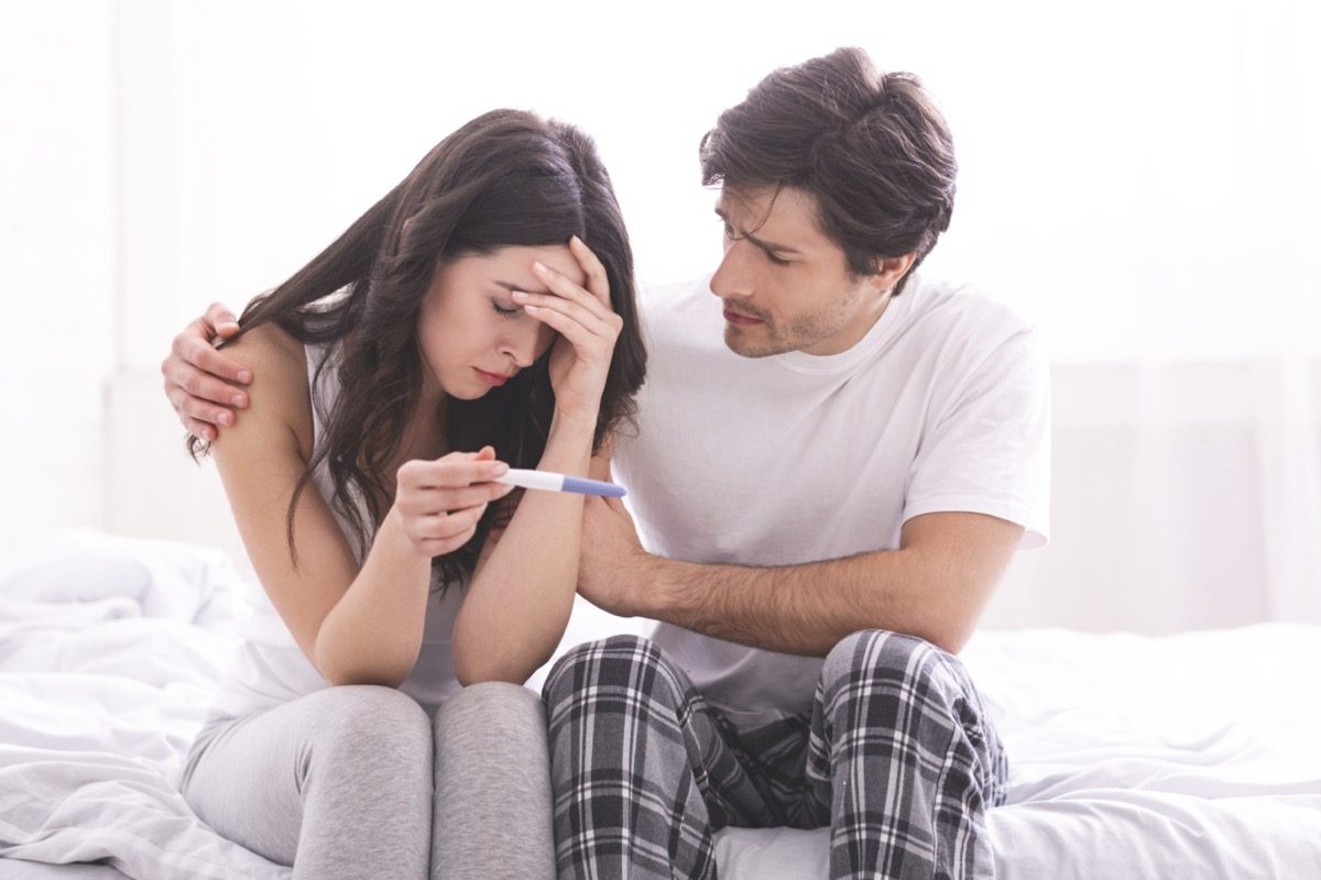 a man who comforts his depressed wife with a negative pregnancy test