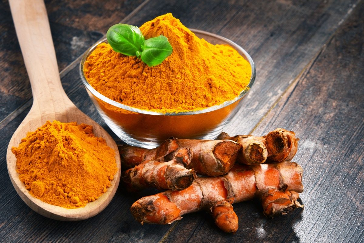 turmeric in bowl and wooden spoon
