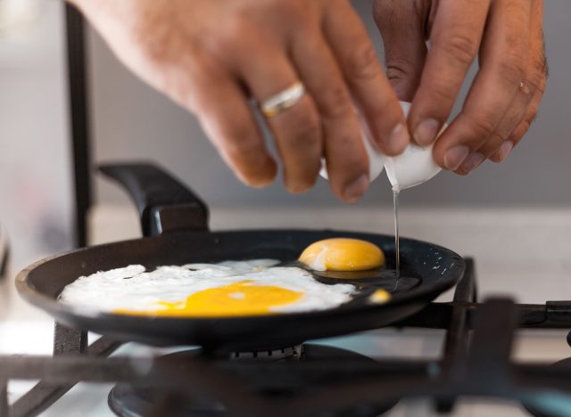 crack eggs in a frying pan