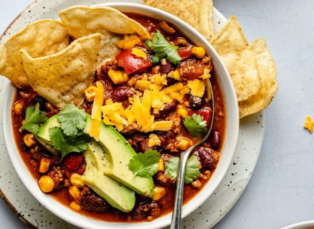 bowl of chili with chips on the side