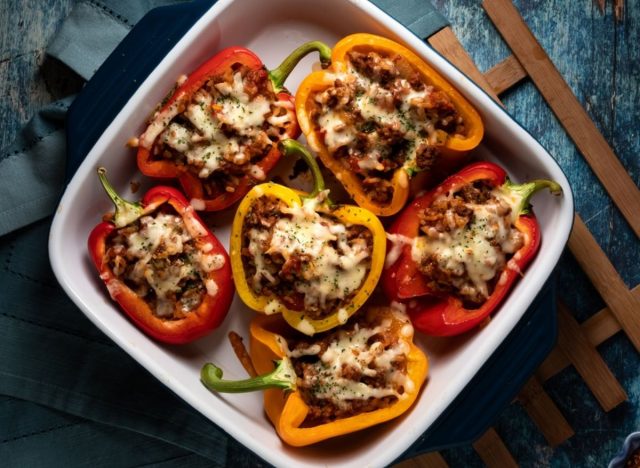 cooked stuffed bell peppers in a white dish