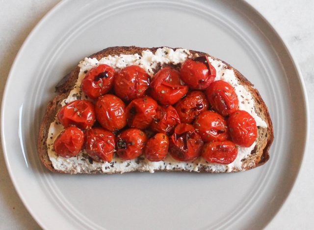 ricotta cheese roasted tomatoes basil balsamic toast on gray plate and marble counter