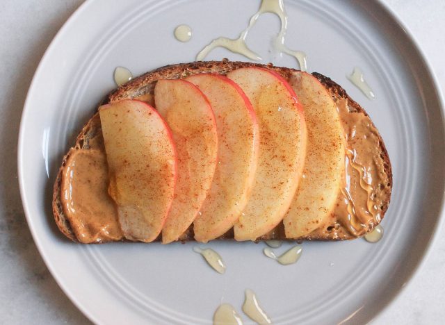 apple peanut butter cinnamon honey toast on gray plate and marble counter